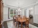 Classic dining room featuring tray ceilings, wainscoting, and a large window for plenty of light at 4910 Conover Dr, Atlanta, GA 30338