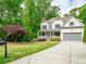 Beautiful two-story home with a covered front porch, well-manicured lawn and two-car garage at 4910 Conover Dr, Atlanta, GA 30338