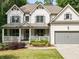 Charming two-story home with a covered front porch, well-manicured lawn and attached two-car garage at 4910 Conover Dr, Atlanta, GA 30338