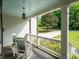 Relaxing covered porch with rocking chairs, a light blue ceiling, and views of the yard at 4910 Conover Dr, Atlanta, GA 30338