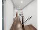 Hallway with hardwood floors, white trim, and a staircase at 4910 Conover Dr, Atlanta, GA 30338