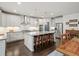 Modern kitchen with stainless steel appliances, a large island with seating, and white cabinets at 4910 Conover Dr, Atlanta, GA 30338