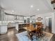 Open kitchen and dining area with a large island, stainless steel appliances, and wood table at 4910 Conover Dr, Atlanta, GA 30338