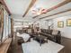 Open-concept living room with wood beams, a leather sofa, hardwood floors, and neutral decor at 4910 Conover Dr, Atlanta, GA 30338