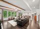 Open-concept living room featuring exposed beams, hardwood floors, and a spacious layout at 4910 Conover Dr, Atlanta, GA 30338