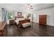 Large main bedroom suite featuring dark hardwood floors, tray ceilings, large windows and ensuite bath access at 4910 Conover Dr, Atlanta, GA 30338