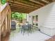 Covered patio with an outdoor dining set with backyard views at 4910 Conover Dr, Atlanta, GA 30338