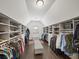 Custom walk-in closet with built-in shelving, hanging rods, a bench, and lots of storage space at 4910 Conover Dr, Atlanta, GA 30338