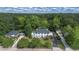 Estate aerial view showcasing mature trees, manicured lawn, and a charming neighborhood at 6104 Floyd St, Covington, GA 30014