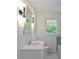 Charming bathroom with a classic vanity, decorative mirror, and tiled walls for a vintage feel at 6104 Floyd St, Covington, GA 30014