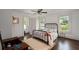Inviting bedroom with ceiling fan, windows, wood floors, and plenty of natural light at 6104 Floyd St, Covington, GA 30014