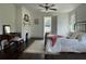 Serene bedroom with natural light, decorative fireplace, and hardwood floors at 6104 Floyd St, Covington, GA 30014