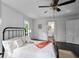 Bright bedroom featuring hardwood floors, a ceiling fan, and natural light from the windows at 6104 Floyd St, Covington, GA 30014