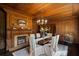 Sophisticated dining room featuring wood trim, fireplace, and a chandelier creating an ideal setting for meals and gatherings at 6104 Floyd St, Covington, GA 30014