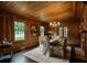 Elegant dining room boasting wood paneling, hardwood floors, fireplace, and a large window providing ample natural light at 6104 Floyd St, Covington, GA 30014