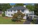 Beautiful white home featuring black shutters, balconies, and a well-manicured lawn at 6104 Floyd St, Covington, GA 30014