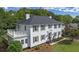 Elegant two-story home with a side porch and beautifully landscaped yard featuring lovely grass and attractive shrubbery at 6104 Floyd St, Covington, GA 30014