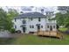 Rear exterior view of home featuring a new wooden deck, upstairs balcony and white paint at 6104 Floyd St, Covington, GA 30014