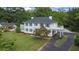 Charming two-story home with black shutters, white balconies, and lush landscaping at 6104 Floyd St, Covington, GA 30014