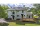 Rear exterior view of home featuring a new wooden deck, upstairs balcony and white paint at 6104 Floyd St, Covington, GA 30014