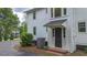 Exterior view of a side entrance, featuring brick steps, white paint, and a black door at 6104 Floyd St, Covington, GA 30014