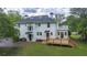 Rear exterior view of home featuring a new wooden deck, upstairs balcony and white paint at 6104 Floyd St, Covington, GA 30014