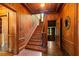 Striking foyer showcasing hardwood floors and the staircase, exuding warmth and sophistication throughout the entryway at 6104 Floyd St, Covington, GA 30014