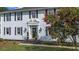 Classic home with black door, black shutters, manicured landscaping, and a well-maintained lawn at 6104 Floyd St, Covington, GA 30014