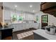 Bright kitchen featuring white cabinets, stainless steel appliances, and natural light, perfect for everyday meal preparation at 6104 Floyd St, Covington, GA 30014