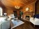Elegant living room featuring rich wood paneling, fireplace and stylish furnishings at 6104 Floyd St, Covington, GA 30014