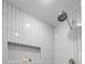 Modern shower space with sleek vertical tiles, built-in niche, and rainfall showerhead at 6104 Floyd St, Covington, GA 30014