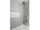 Modern shower with gray tile walls and a built-in niche, offering a clean and contemporary design at 6104 Floyd St, Covington, GA 30014