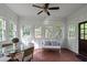 Bright sunroom features tile flooring, panelling, lots of windows, and comfortable seating at 6104 Floyd St, Covington, GA 30014