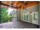 Covered back porch with ceiling fans, stamped concrete floor and a view of the private backyard at 704 Willowwind Dr, Loganville, GA 30052