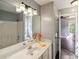 Bathroom featuring double sinks, vanity and access to a bedroom at 704 Willowwind Dr, Loganville, GA 30052