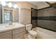 Bathroom with tile shower, new gray vanity and lighting at 704 Willowwind Dr, Loganville, GA 30052