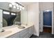 Bathroom with double vanity and an ornate, stone walk-in shower at 704 Willowwind Dr, Loganville, GA 30052