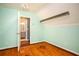Nicely painted bedroom with hardwood floors looking into the primary bath at 704 Willowwind Dr, Loganville, GA 30052