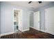 Comfortable bedroom with gleaming hardwood floors, ensuite bath, and two closets at 704 Willowwind Dr, Loganville, GA 30052