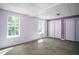 Cozy bedroom with concrete flooring, dual windows, and closet with sliding doors at 704 Willowwind Dr, Loganville, GA 30052