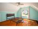Cozy bedroom with natural light, complemented by wood floors and a ceiling fan at 704 Willowwind Dr, Loganville, GA 30052