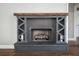 Striking fireplace featuring a unique wood beam mantel and riveted steel construction at 704 Willowwind Dr, Loganville, GA 30052