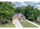 Beautiful two-story home with brick accents, a lush lawn, and a long driveway at 704 Willowwind Dr, Loganville, GA 30052