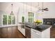 Spacious kitchen featuring granite counters, stainless appliances and a fireplace at 704 Willowwind Dr, Loganville, GA 30052