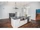 Open kitchen layout with island, fireplace and access to stairs at 704 Willowwind Dr, Loganville, GA 30052