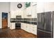 Kitchen featuring stainless steel appliances and wooden floors at 704 Willowwind Dr, Loganville, GA 30052
