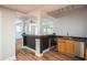 Basement kitchenette with dark countertop, dark wood trim, stainless steel refrigerator and sink at 704 Willowwind Dr, Loganville, GA 30052