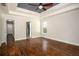 Large main bedroom featuring tray ceilings, an ensuite bathroom and hardwood floors at 704 Willowwind Dr, Loganville, GA 30052