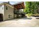 A covered deck offering shade and outdoor relaxation, alongside a backyard with landscaped features at 704 Willowwind Dr, Loganville, GA 30052