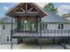 Covered deck featuring timber detailing with a ceiling fan, patio access, and backyard access at 704 Willowwind Dr, Loganville, GA 30052